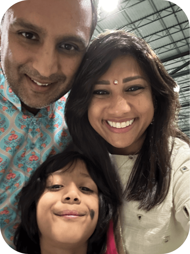 kavita with her husband and son smiling
